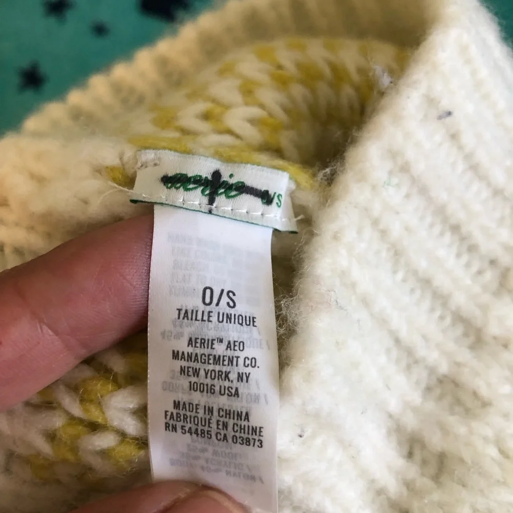 eerie off white and yellow beanie with pompom one size fits most